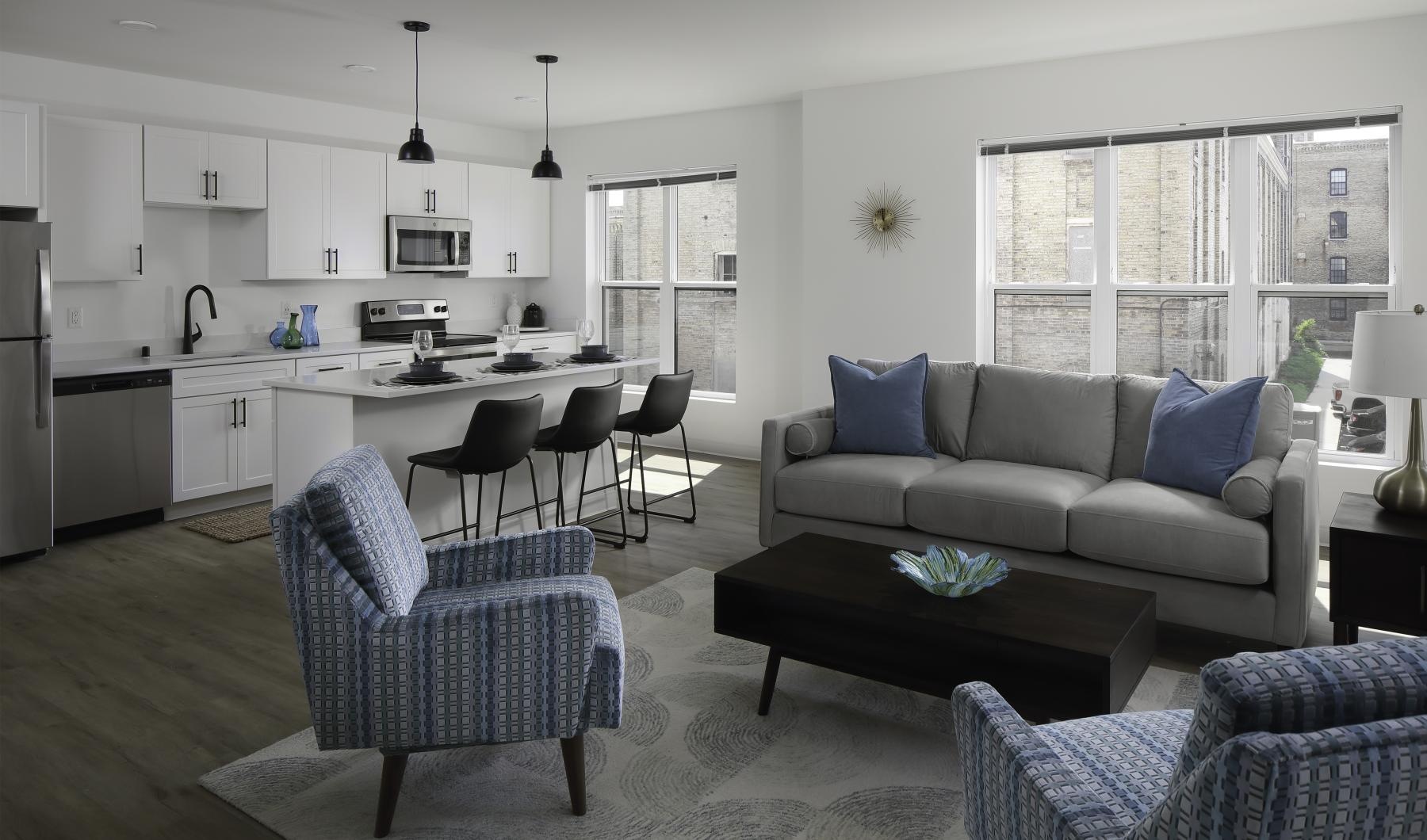 a living room with a couch and chairs